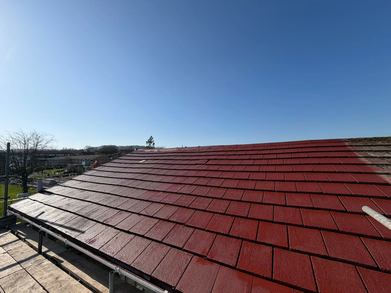 Elevated photograph of a finished roof, part of the before and after record